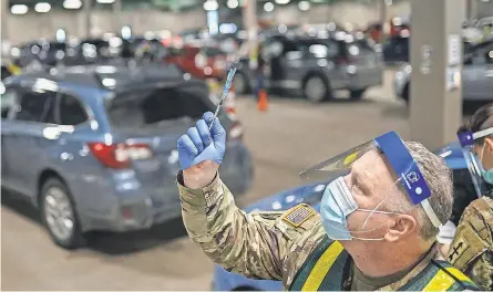  ?? RYAN GARZA/ USA TODAY NETWORK ?? The pace of vaccinatio­ns, including at this drive- up site in Michigan, may not be fast enough to prevent variants from gaining a foothold. If the infectious­ness and fatality rate for the B. 1.1.7 variant in the U. S. is like it is in the U. K., some experts worry that the country could see a staggering death toll by summer and fall.