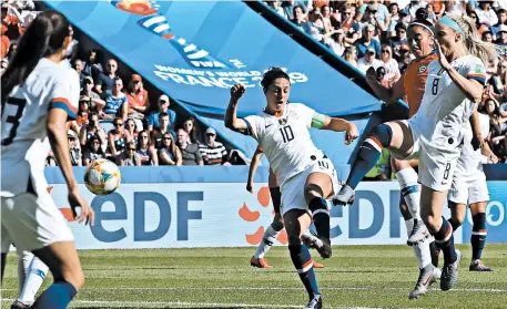  ?? ALESSANDRA TARANTINO/AP ?? Carli Lloyd sends the ball toward the net for the opening goal in the U.S. team’s 3-0 victory over Chile at the World Cup.