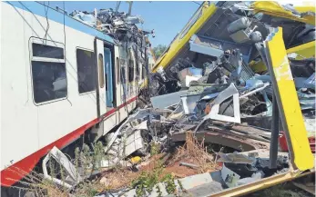  ?? LUCA TURI, EUROPEAN PRESSPHOTO AGENCY ?? Two four-carriage trains collided head-on on a single-track stretch between Ruvo di Puglia and Corato in southern Italy on Tuesday. Italian leaders demanded to know how it happened.