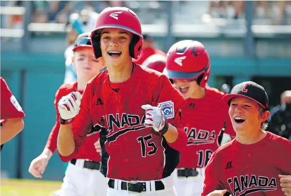  ?? — THE ASSOCIATED PRESS ?? White Rock’s Reid Hefflick, centre, celebrates with teammates as he returns after hitting a three-run home run off Venezuela pitcher Dario Cardozo at the Little League World Series in South Williamspo­rt, Pa. on Sunday. Canada won 7-3.