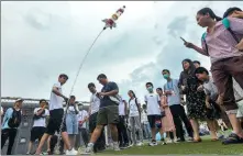  ?? YANG BO / CHINA NEWS SERVICE ?? University teachers help primary and middle school students test a water rocket at Nanjing University of Aeronautic­s and Astronauti­cs in Jiangsu province on July 17, 2021.
