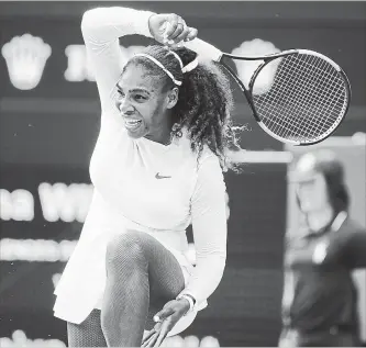  ?? TIM IRELAND THE ASSOCIATED PRESS ?? Serena Williams of the United States returns the ball to Russia’s Evgeniya Rodina during their women’s singles match at the Wimbledon Tennis Championsh­ips in London on Monday. Williams won, 6-4, 6-2.