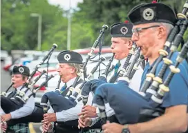  ??  ?? MacKenzie Caledonian Pipe Band led the workers out.