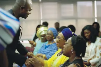  ??  ?? Kingsley Moghalu interactin­g with women at an event in Lagos