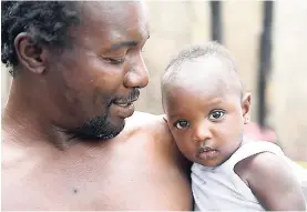  ??  ?? Anthony Foster cuddles his daughter, Jowana, who celebrates her first birthday today.