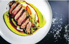  ??  ?? Duck breast with ginger honey, wasabi mashed potatoes and wok vegetables, as created by Mario Gross.