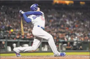  ?? Tony Avelar / Associated Press ?? The Dodgers’ Cody Bellinger gets a hit against the Giants on Sept. 27. Bellinger was well on his way to becoming the NL MVP only 60 games into last season, already with 20 homers in that stretch before his 24th birthday.