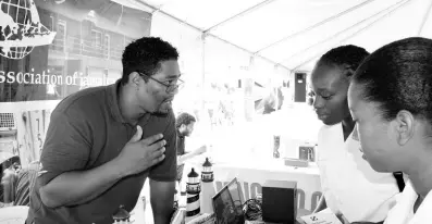  ??  ?? Amado Danni, stevedore of the Shipping Associatio­n of Jamaica, interacts with students at the Maritime Awareness Week exposition on Tuesday, September 24.