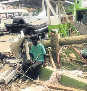  ??  ?? A man sits amid the devastatio­n in the Virgin Islands.