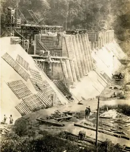  ??  ?? At top left, a sailboat cruises Lake Hamilton at sunset. At right, constructi­on progresses on the Blakely Mountain Dam power plant, 1953. At bottom, constructi­on on the Remmel Dam in the early 1920s.