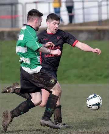  ??  ?? Mark Mythen of Bridge Rovers and John Kavanagh of Gorey Celtic battle for possession during their Premier Division match at The Bogside on Sunday.