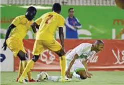  ??  ?? BLIDA: Algeria’s Yacine Brahimi (R) reacts as Togo’s Atchou Koffi Franco (C) and Lalawele Atakora (L) look on during their 2019 African Cup of Nations qualificat­ion Group D football match between Algeria and Togo at the Mustapha Tchaker stadium in...