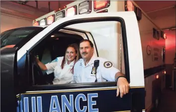  ?? Erik Trautmann / Hearst Connecticu­t Media ?? Paramedic Walter Hughes, right, and his daughter, EMT Kristina Hughes, at Greenwich GEMS station 3 in August. Walter, a long-term employee of the Greenwich Emergency Medical Services, and his daughter, a recent addition to the team, collaborat­ed on a resuscitat­ion to save a life last month.