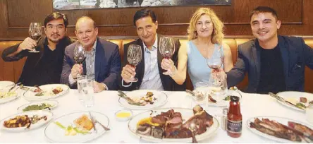  ?? Photos by JESSE BUSTOS ?? Raising the steaks: Peter Zwiener (center), president of Wolfgang Steakhouse, raises a toast to new Podium branch with partners (from left) Raymund Magdaluyo, executive chef Amiro Cruz, training head Lydia D’Amato and Marvin Agustin.