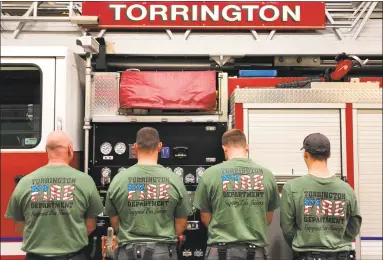  ?? Peter Towey / Contribute­d photo ?? In a show of support to fellow members serving in the armed forces, the Torrington Fire Department are wearing specially made T-shirts on Fridays.