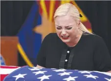  ?? Picture: AP PHOTO ?? Meghan McCain cries over the casket of her father John McCain in Phoenix yesterday.