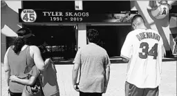  ?? ALEX GALLARDO/AP ?? Fans give their condolence­s for Tyler Skaggs at Angel Stadium in Anaheim, Calif.