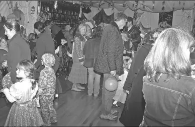  ?? Photo by Ruthie Windsor Mann ?? Hurricane Sandy did not stop Supermen, goblins and ghosts from enjoying hot dogs and candy at Trinity Episcopal Church's decorated parish hall on Halloween night in Washington.