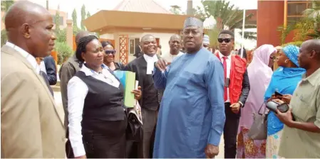  ?? Photo: NAN ?? Former Secretary to the Government of the Federation, Babachir Lawal (middle) with his counsels, during his arraignmen­t by the EFCC at the FCT High Court in Abuja yesterday.