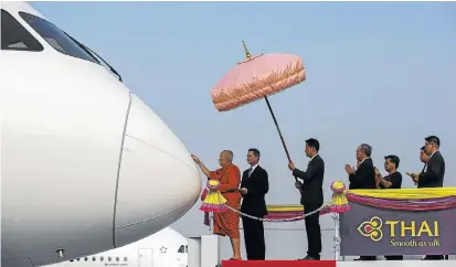  ?? Picture: REUTERS ?? A Thai Buddhist monk blesses a Boeing B787-8 Dreamliner named Pranburi during an aircraft-anointing ceremony at Bangkok’s Suvarnabhu­mi Internatio­nal Airport on Friday