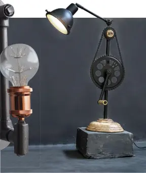  ??  ?? BLACK MAGIC An industrial style wall light (left); limited edition Sprocket Wheel Desk Lamp (right)