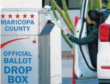  ?? AP PHOTO/ROSS D. FRANKLIN ?? A voter drops off a ballot for the Arizona Democratic presidenti­al preference election Tuesday in Phoenix.