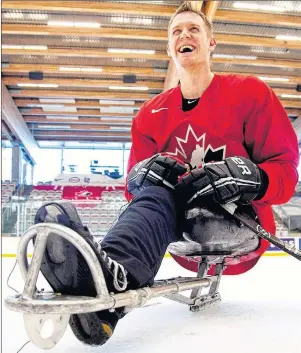  ?? CP PHOTO ?? Dominic Larocque of Quebec City, a former soldier who lost his leg in Afghanista­n and who now plays for the Canadian sledge hockey team, practises with teammates in Calgary on Tuesday, Dec. 4, 2012.