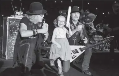  ?? Photos by Steve Peterson, TerraChrom­a ?? Musical performers Big and Rich invite Kaley McGill, a Children’s Hospital Colorado ambassador, onstage.