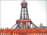  ?? GU LANDING / FOR CHINA DAILY ?? Workers stand in front of Songke 2, the deepest borehole ever drilled for scientific purposes by Asians, in Anda, Heilongjia­ng province, on Saturday.