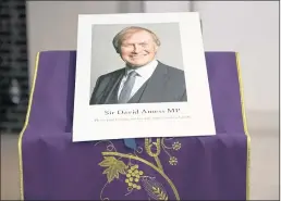  ?? ALBERTO PEZZALI — THE ASSOCIATED PRESS FILE ?? An image of murdered British Conservati­ve lawmaker David Amess is displayed near the altar in St. Peter’s Catholic Church in Leigh-on-Sea, Essex, England.