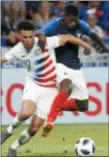  ?? LAURENT CIPRIANI — THE ASSOCIATED PRESS ?? Antonee Robinson, left, battles for the ball with France’s Ousmane Dembele during a friendly match in Decines, France on Saturday. The Associated Press