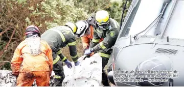  ??  ?? Colombian air force helicopter retrieves the bodies of victims from a plane that crashed into the Colombian jungle. — Reuters photo