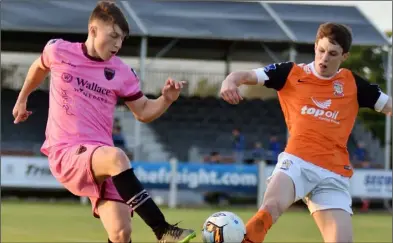  ??  ?? Striker Danny Doyle battles for the ball with Athlone Town defender David Brookes.