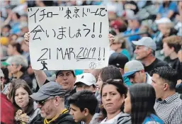  ?? ASSOCIATED PRESS FILE PHOTO ?? Jeff Craddock of Canada, holds a sign written in Japanese that says he hopes to see Ichiro Suzuki play in a game between the Mariners and the Oakland Athletics set for March 21, 2019, in Tokyo, as he sits in the stands at Safeco Field in Seattle on...