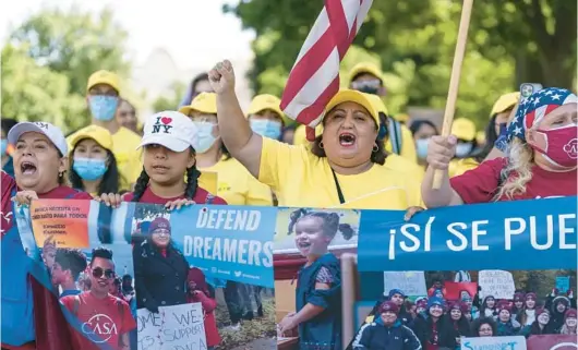  ?? J. SCOTT APPLEWHITE/AP ?? Ingrid Vaca, center, a native of Bolivia, leads a chant at a rally in support of the DACA program Wednesday at the U.S. Capitol. The program went into effect June 15, 2012.