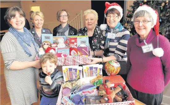  ??  ?? DonationWo­men for Independen­ce members (left to right) Janine Calikes with son Otis (3), Carolyn Ritchie and Gillian Mair present hampers to foodbank volunteers Jo Simpson, Margaret Wotherspoo­n and Jean Buchanan