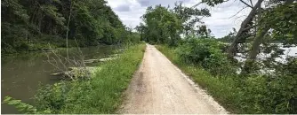  ?? DALE BOWMAN/SUN-TIMES ?? ABOVE: The 13-mile I&M Canal State Trail in Channahon is part of the Will County Triple Crown Challenge. BELOW: A doe drinks from the I&M Canal within earshot of I-55.