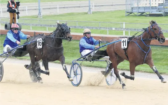  ??  ?? Monbet beats his stablemate Quite A Moment in the Dominion Trot at Addington yesterday in national record time. Matt Smith