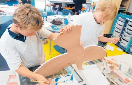  ?? ?? Waipawa School students Danny Beale and Casey Nielson — part of teacher Peter Burns’ room 11 class of 2021 — working on one of the elements of the mural.