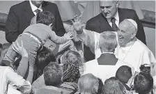  ?? THE ASSOCIATED PRESS ?? Pope Francis salutes a child after leading the Easter Sunday Mass in St. Peter Square at the Vatican.