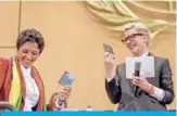  ?? — AFP ?? GENEVA: Australian actress and UNHCR ambassador Cate Blanchett (right) and formerly stateless refugee in Brazil, Maha Mamo show their passport during an UNHCR executive committee meeting yesterday in Geneva.