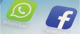  ??  ?? Photo shows WhatsApp and Facebook app icons on a smartphone in New York.