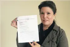  ?? JENNIFER ACKERMAN ?? Coleen Rajotte holds up a Notice of Objection form, which is part of a national movement to oppose the Sixties Scoop settlement agreement proposed by the Canadian government and prompt a renegotiat­ion of the agreement.