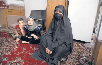  ?? VAHID SALEMI/AP ?? Afghan refugee Zahra Husseini and her children Salehe, center, and Shahrzad last month in Tehran, Iran.