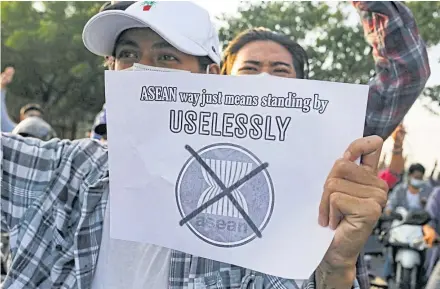  ?? REUTERS ?? A protester against Myanmar’s military junta holds a placard criticisin­g the Associatio­n of Southeast Asian Nations (Asean) in Mandalay, Myanmar on June 5, 2021.