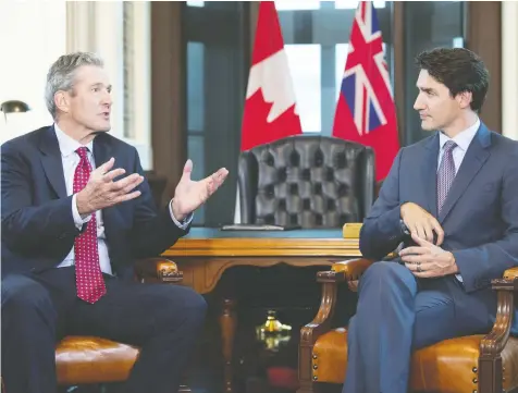  ?? ADRIAN WYLD / THE CANADIAN PRESS FILES ?? Manitoba Premier Brian Pallister meets with Prime Minister Justin Trudeau in Ottawa in May. To alleviate some of the frustratio­ns bubbling in Western provinces, Pallister says Ottawa needs to “get things done,” such as building infrastruc­ture that will mitigate the effects of climate change.