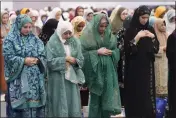  ?? DAMIAN DOVARGANES — THE ASSOCIATED PRESS ?? American Muslim women pray to mark the end of the holy month of Ramadan in Los Angeles on Wednesday.