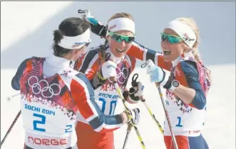  ?? MATTHIAS SCHRADER/AP PHOTO ?? Norway’s, from left, Marit Bjoergen, Kristin Stoermer Steira and Therese Johaug celebrate after sweeping the medals in the women’s 30K cross-country sking finals Saturday at Krasnaya Polyana, Russia. Bjoergen won the gold, Johaug took the silver and...