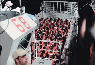  ?? KENNY KARPOV THE ASSOCIATED PRESS ?? This photo released by SOS Méditerran­ée on Twitter shows migrants about to board the SOS Mediterran­ee's Aquarius ship. Italy and Malta dug in for a second day and refused to let the rescue ship dock in their ports.