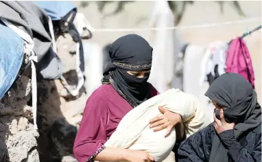  ?? PICTURE: REUTERS ?? DESPERATE: A woman carries her child at a camp for people displaced by the war, near Sana’a, Yemen, yesterday.